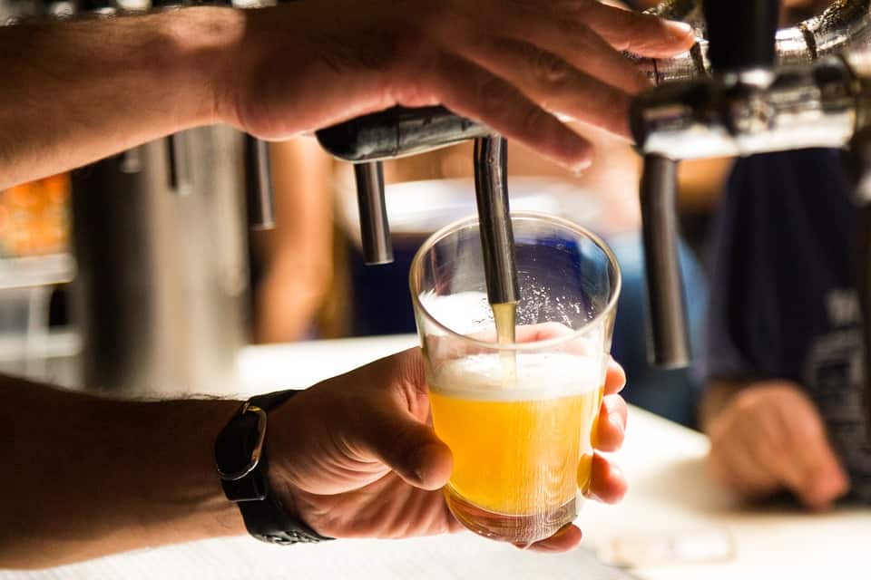 Man Filling a Glass with a Craft Beer from the Distillery at the Avery Brewing Company