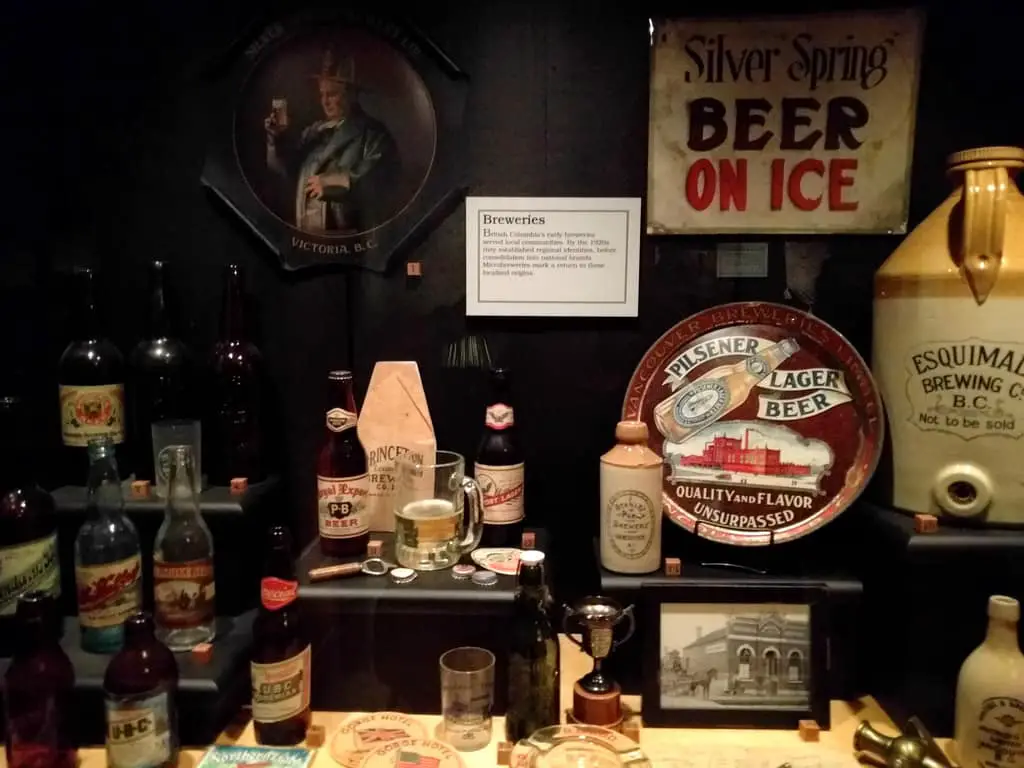 Exhibit about the History of Beer with the Bottles of Beers from Europe and America with beer glasses and materials for fermenting