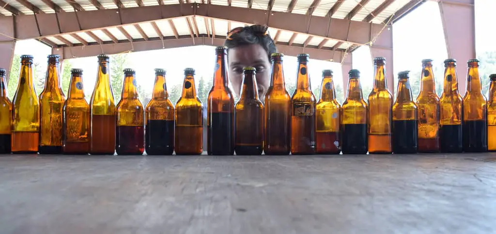 Man Staring at Bottles of Beer