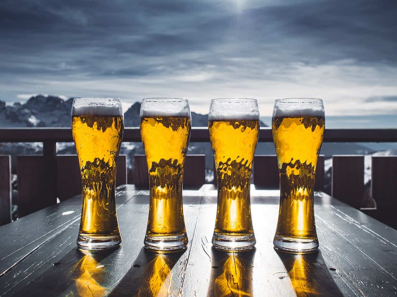 4 beers sitting on a table; types of beer