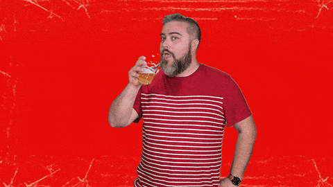 man drinking a glass of beer